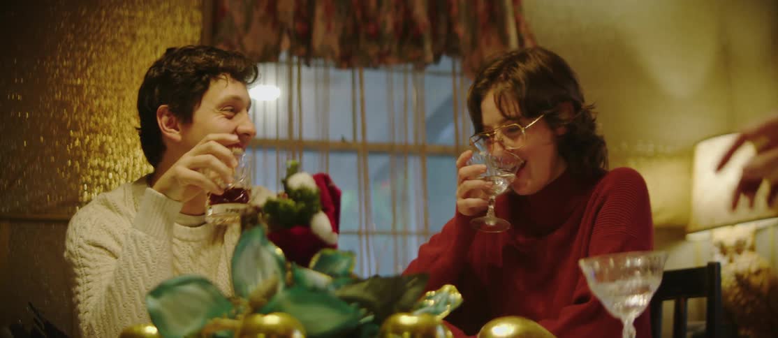 People laugh and drink at a party