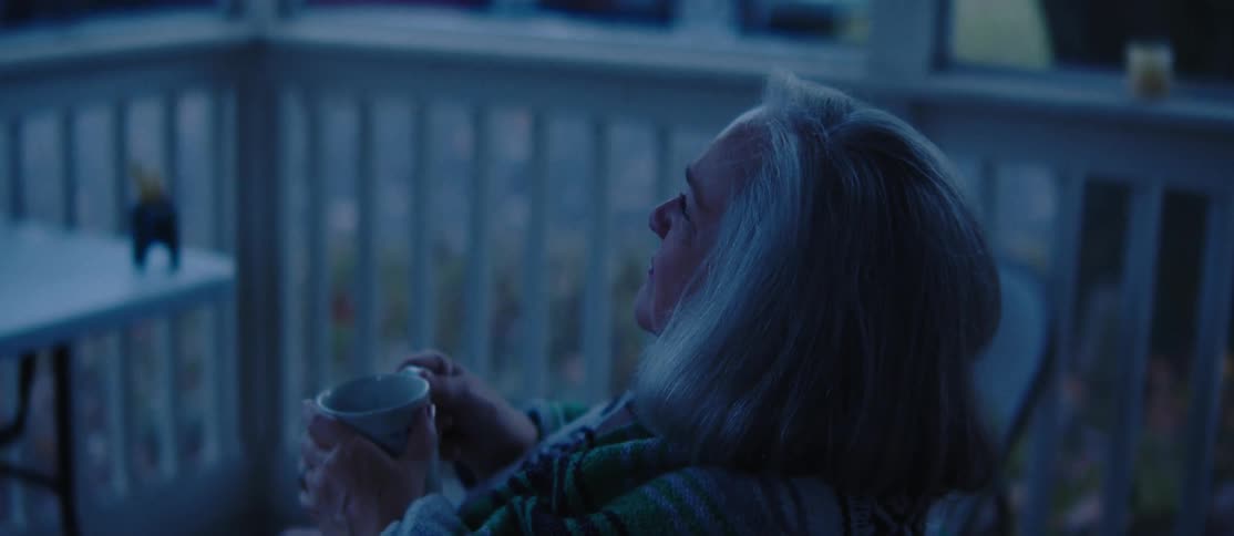 A clop of an elderly woman sitting outdoor