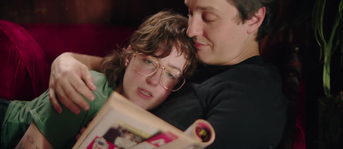 Couple lying together with a woman reading a book