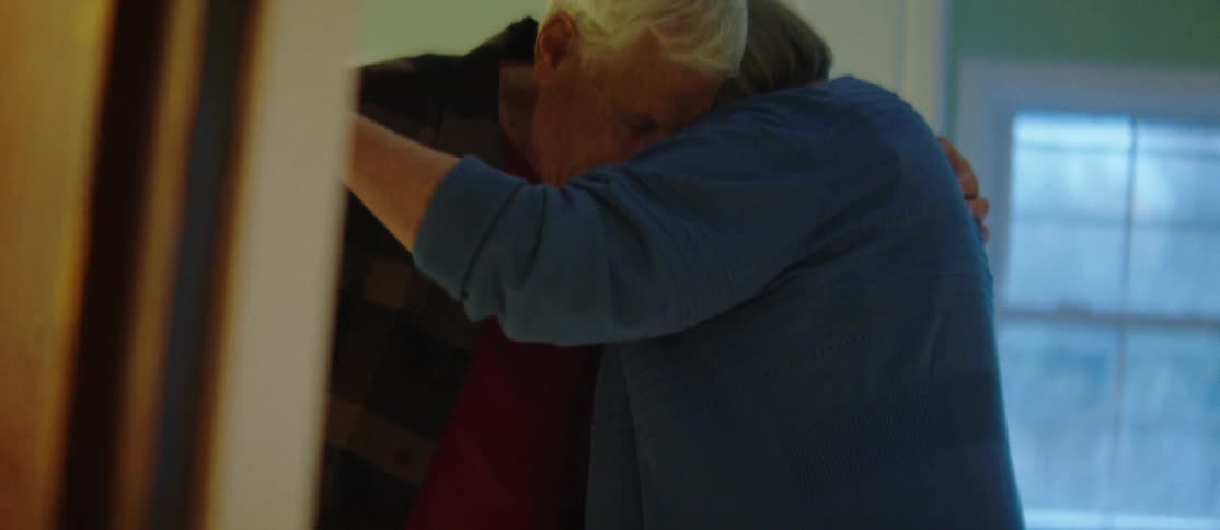 A couple dance in a room