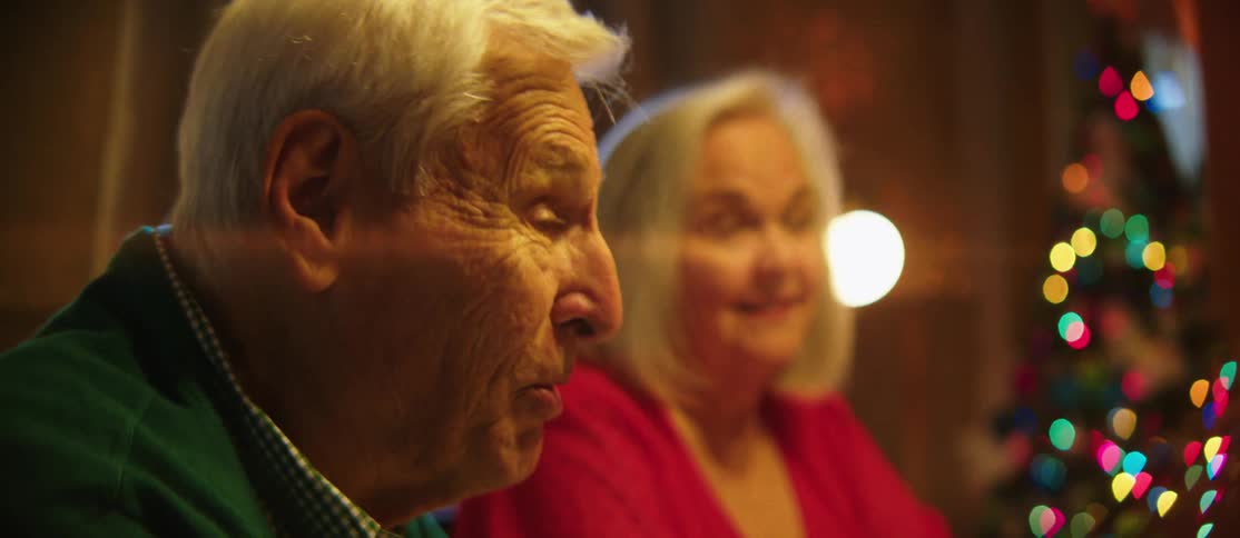 Man and an elderly woman sitting and talking
