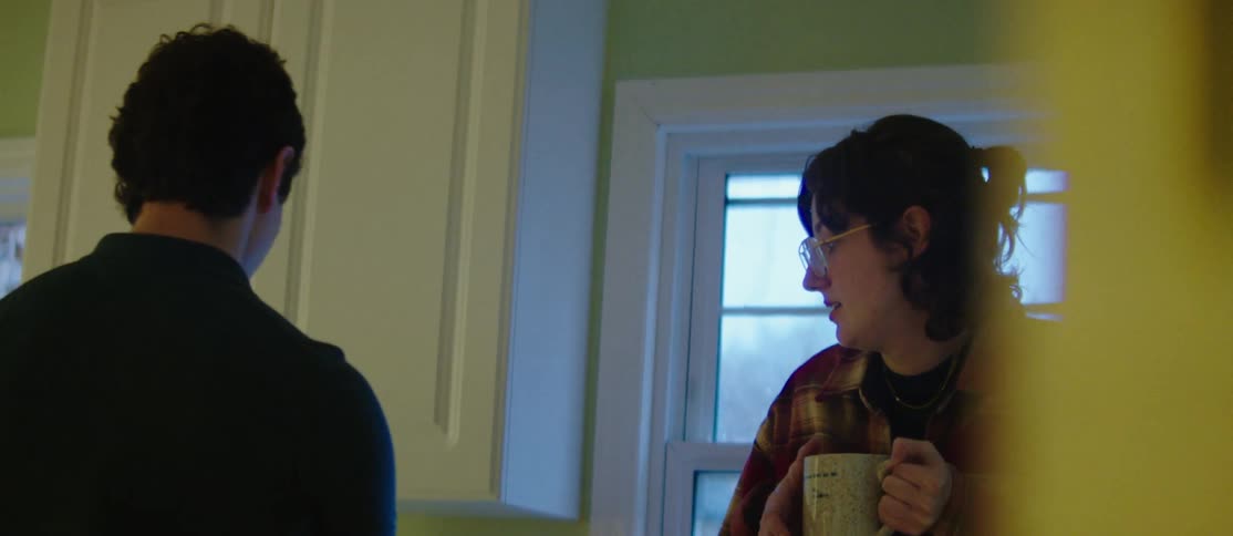 A young couple drinking hot beverages at home