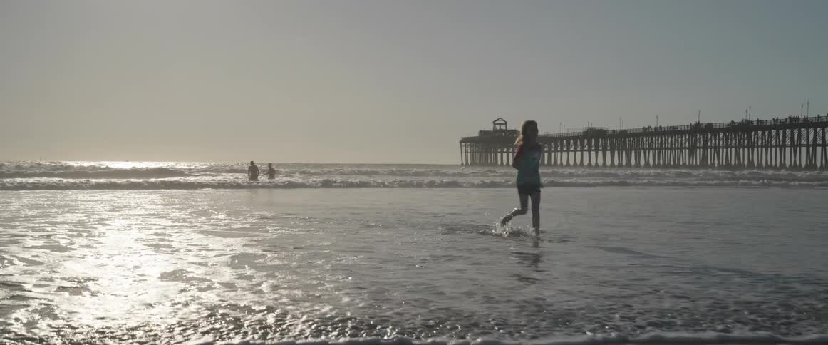 Girl running out of the sea