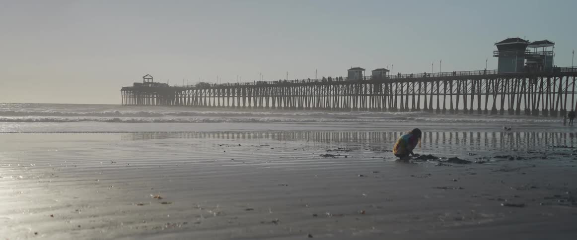 Child playing in the sand on the beach