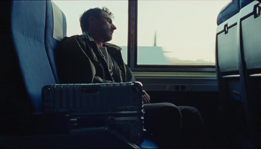 Man sleeping on the window of a moving bus