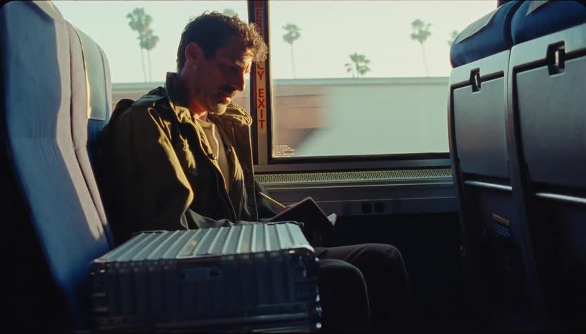 A clip of a person writing inside a public transport