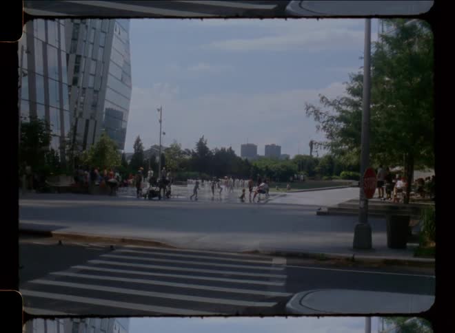 People in a square with a fountain in a metropolis