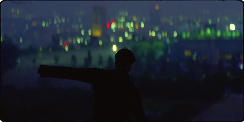 Silhouette of a man outdoors dancing at night