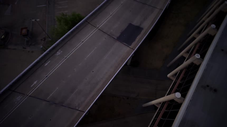 Aerial view of a motorcycle passing under an overpass