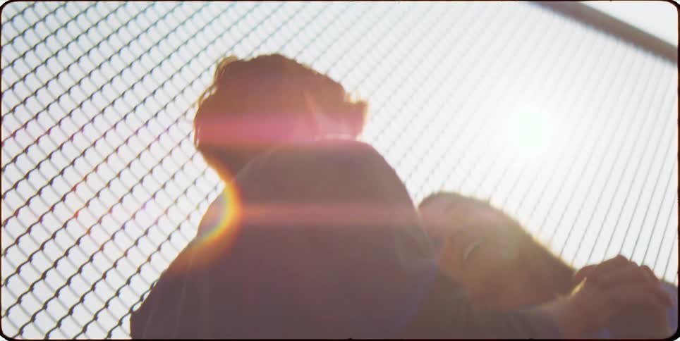 Couple holding hands next to a large