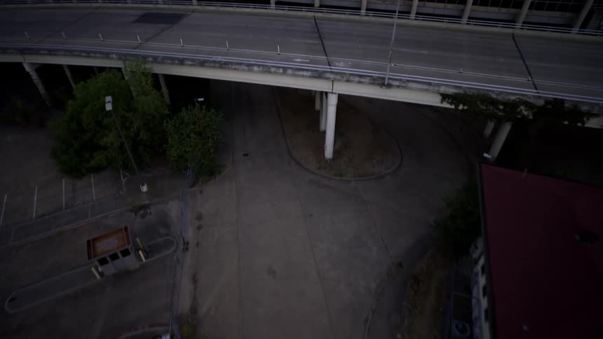 Aerial view of a motorcycle passing under overpasses