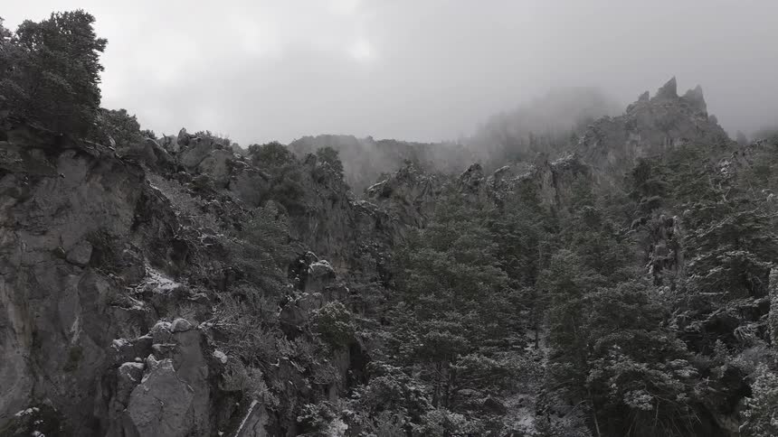 Aerial panorama of mountains with erosions on a foggy day