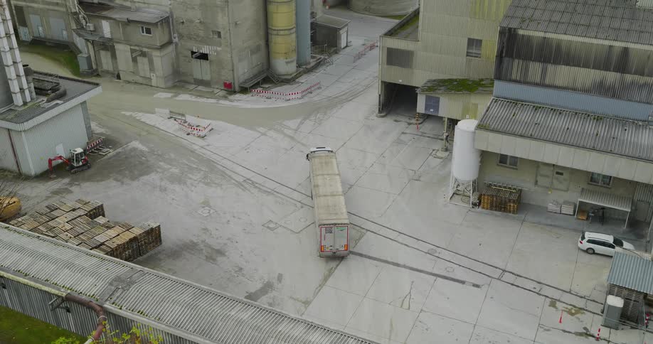 Aerial view of a cargo truck traveling through a logistics center