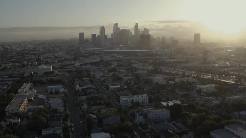 A large city sits in the distance at sunset