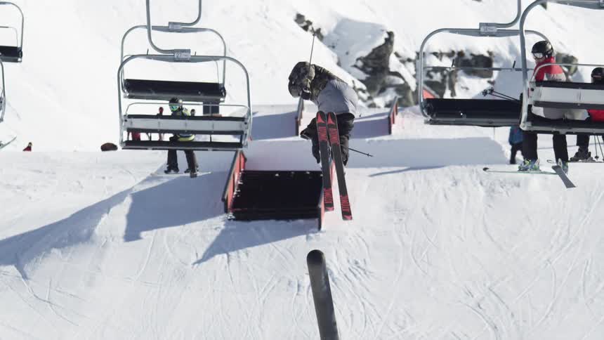 Person making a high jump on a ski slope