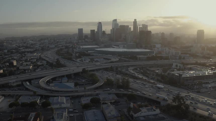 Traffic flows along freeways in a city at dawn