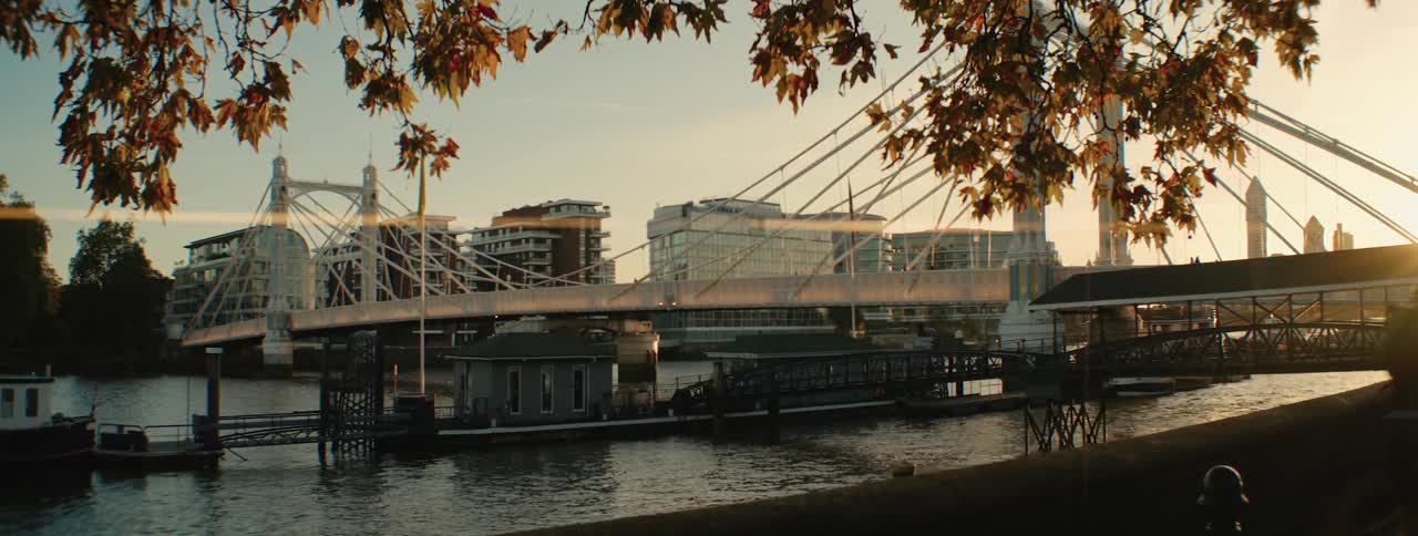 Cyclist rides his bicycle along the waterfront across from the docks during a fall day