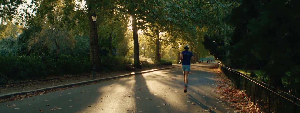 Man with headphones running in a park