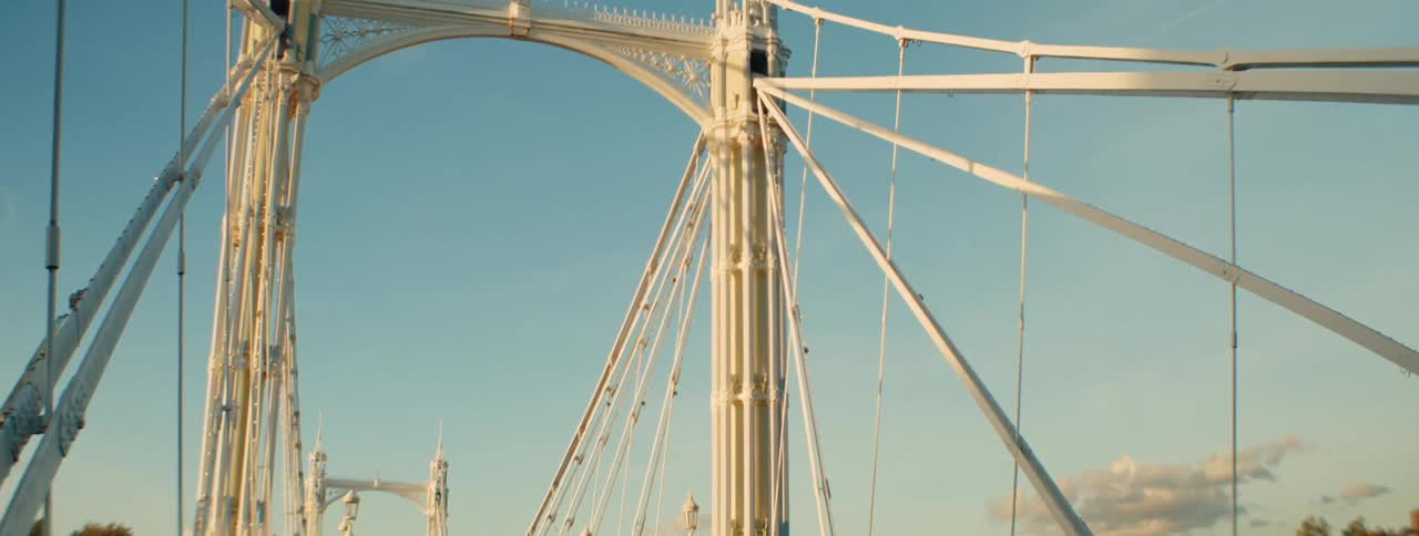 People crossing a bridge by vehicle and walking