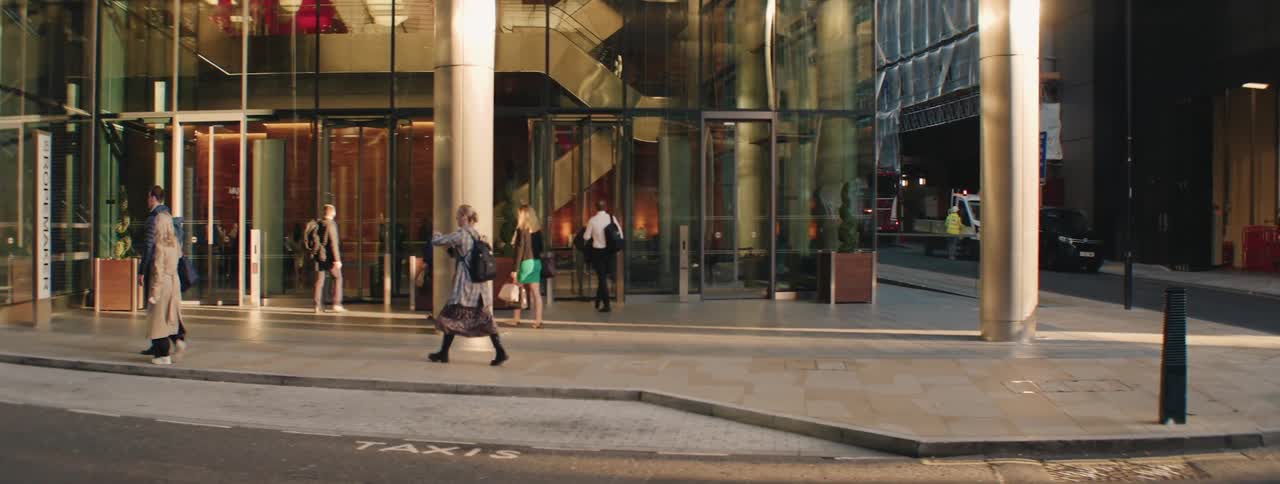 Pedestrians walking on a sidewalk in a metropolis