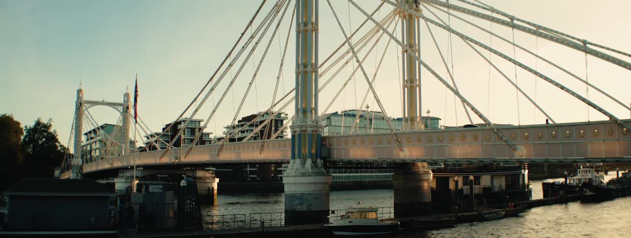 Albert bridge in london with its distinctive suspension cables and ornate details spanning the river thames at sunset
