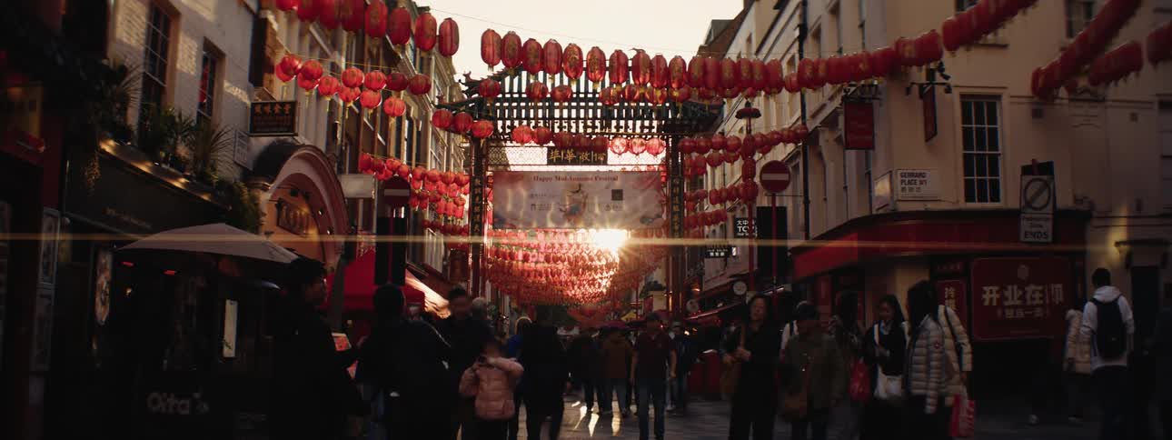 Shoppers walk through the plaza filled with stores