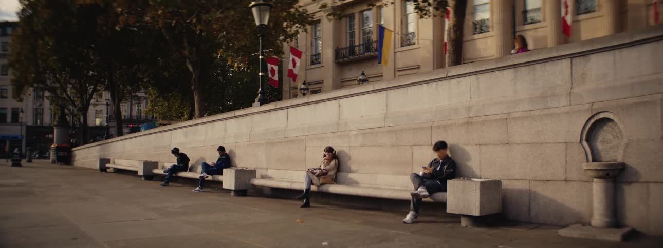 People sitting on benches in a public square