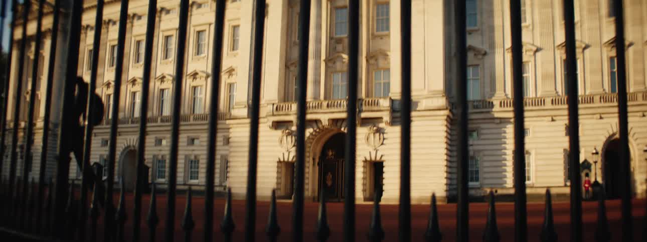 Classic british royal building seen through a black gate