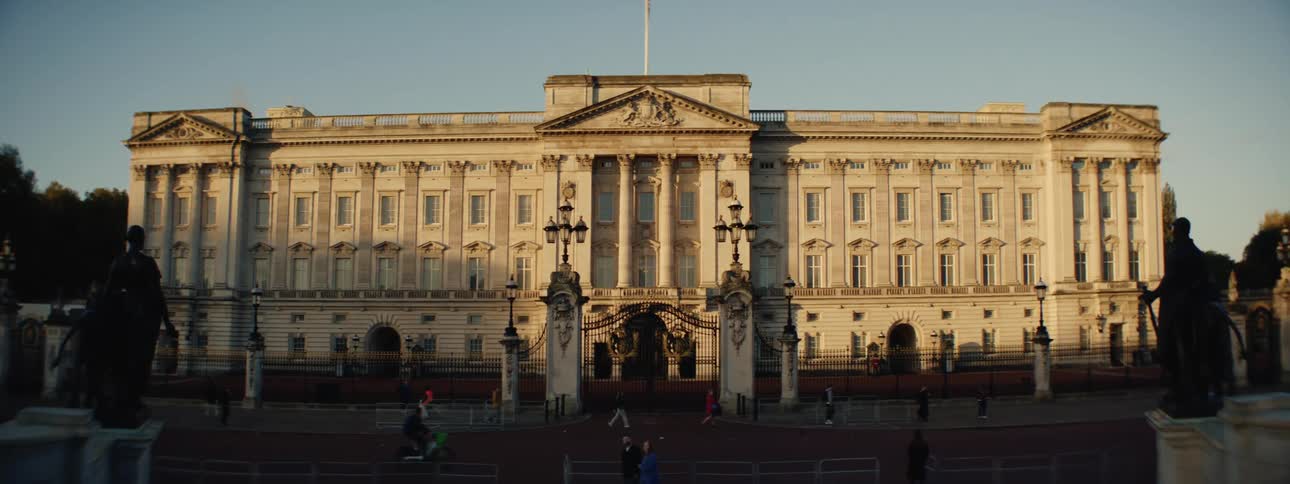 The buckingham palace the official london residence of the british monarch bathed in the warm glow of the setting sun