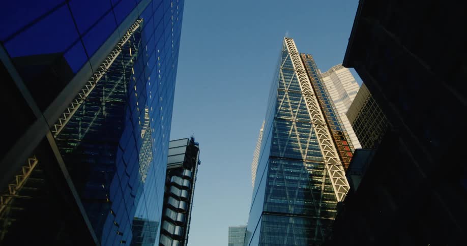 Upward view of skyscrapers against a blue sky in a metropolis