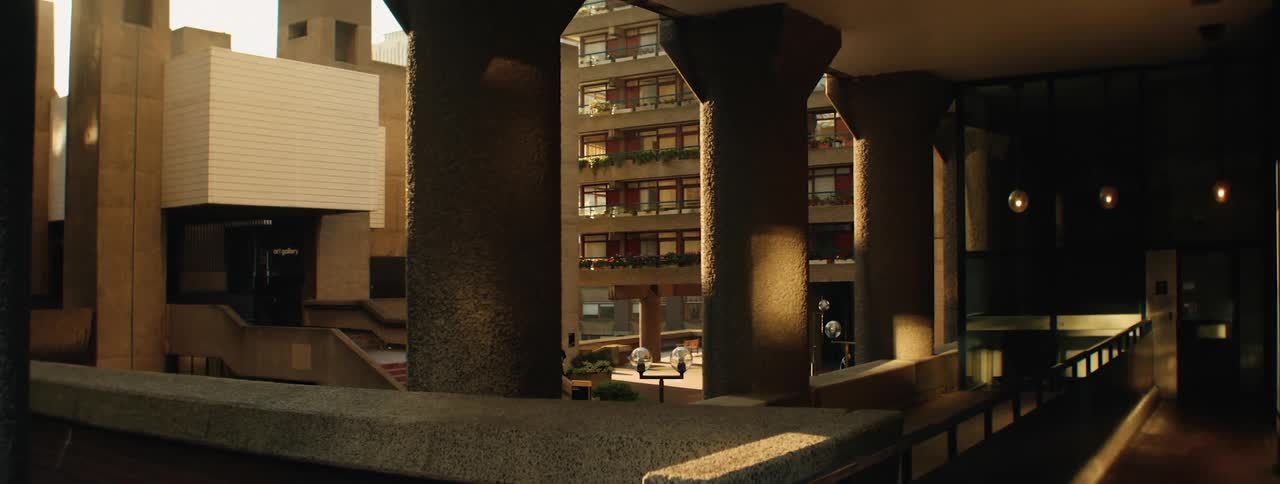 Sunlight casts shadows on the concrete pillars and walkways of the barbican centre part of the barbican estate revealing its distinctive architecture