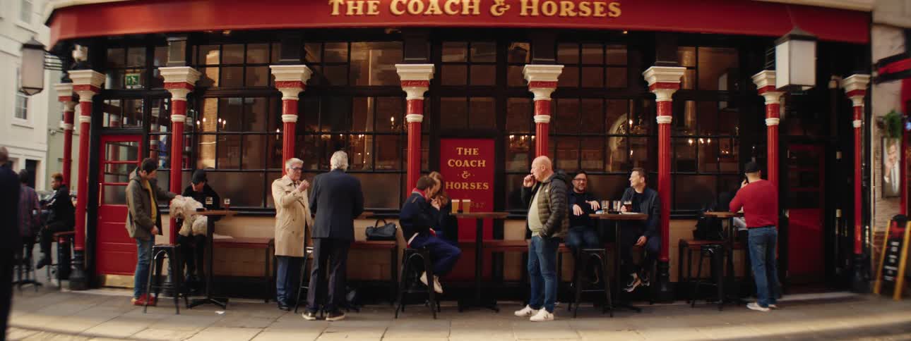 People enjoy themselves while at the outside tables of the coach and horses pub during the day