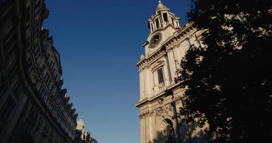 Tall church buildings with arches are standing tall in a city