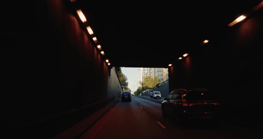 Moving view through a tunnel with traffic in a metropolis