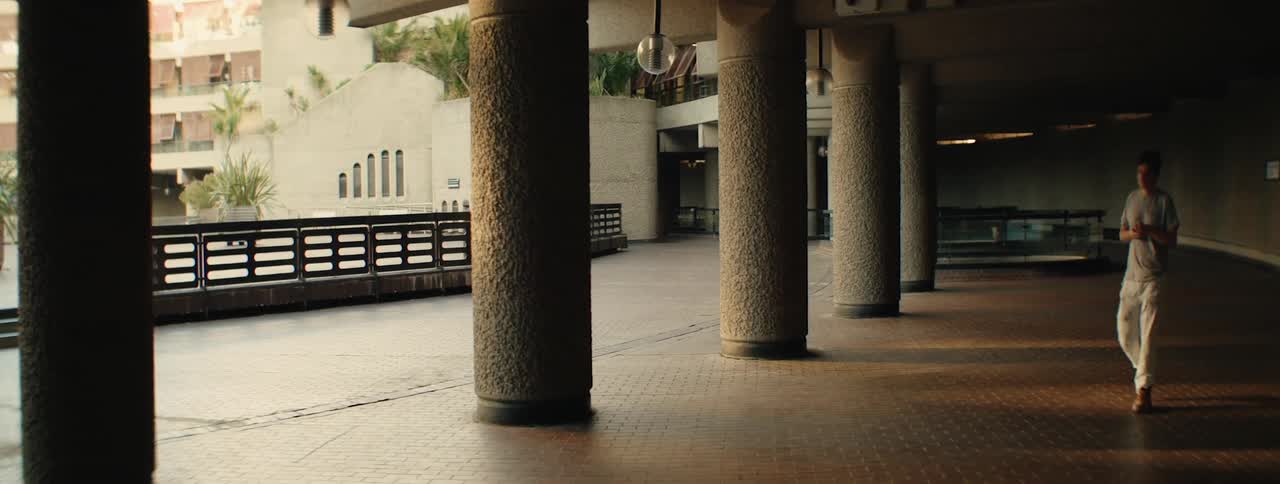 A man walks down the corridor of a building