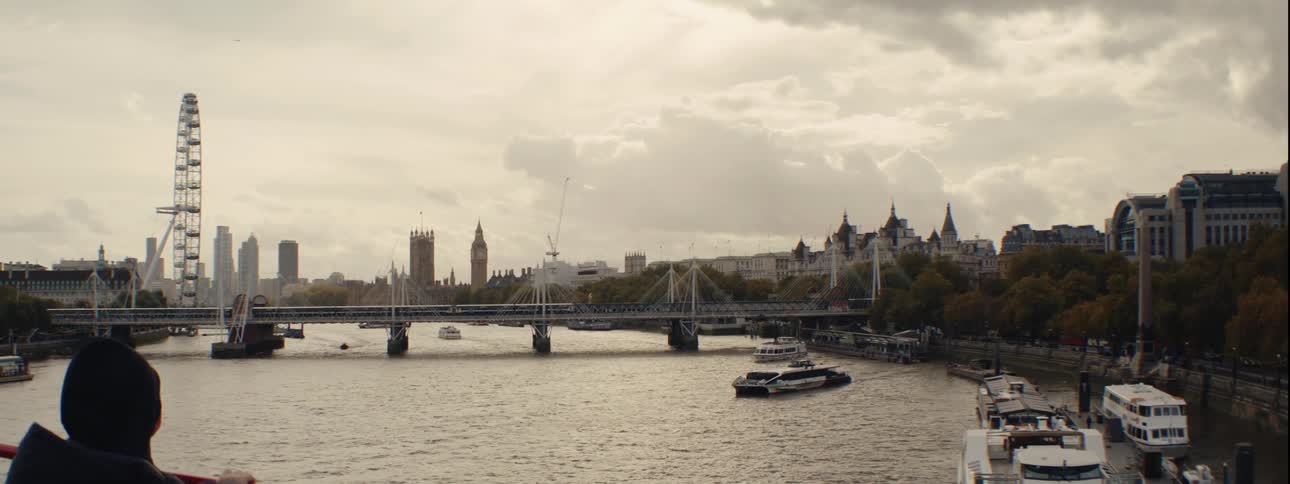 A view of the river thames in london featuring the london eye on the left the houses of parliament and big ben in the center