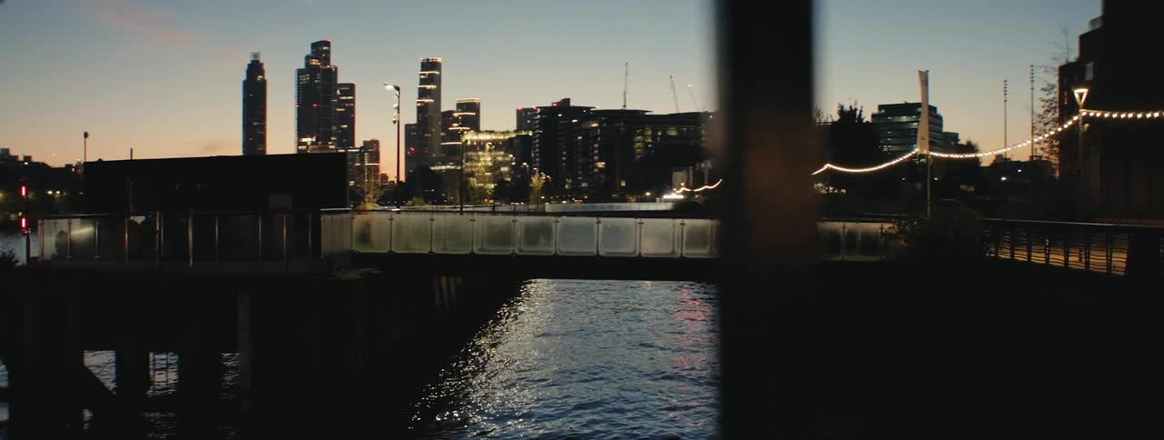 Urban buildings and skyscrapers with a sea canal in a metropolis at night