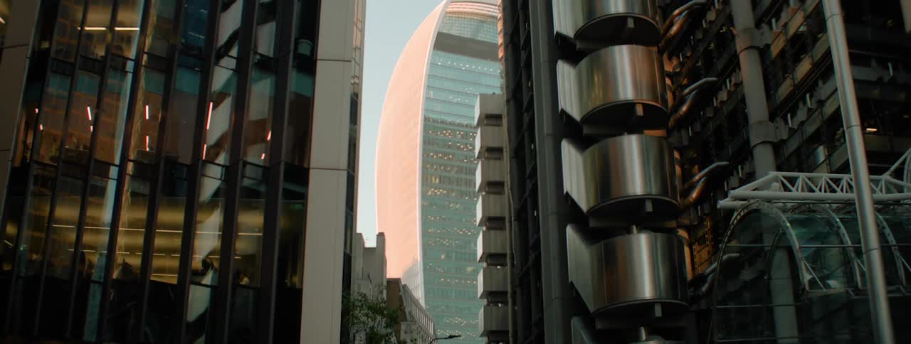 The facade of some commercial buildings and skyscrapers in a big city with blue sky