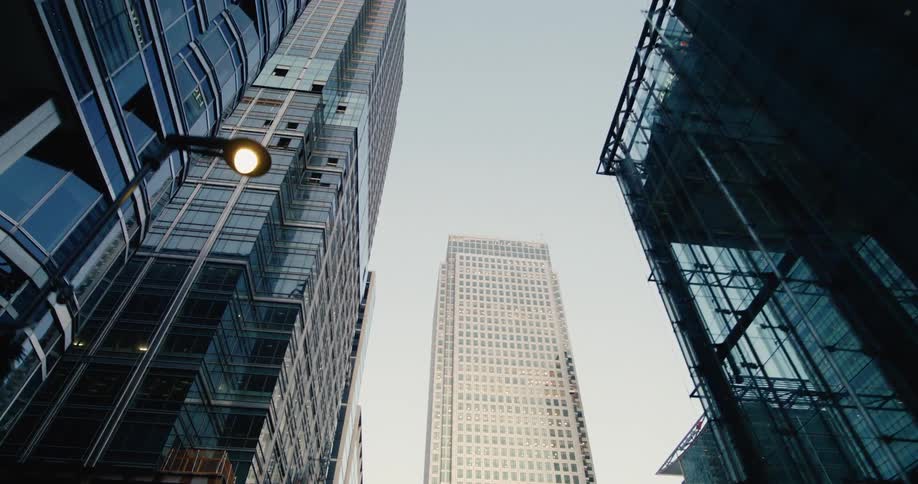 The tall buildings fill the cloudy sky
