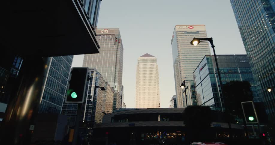 A street view looking up at several tall modern office buildings in a city including one with the hsbc logo