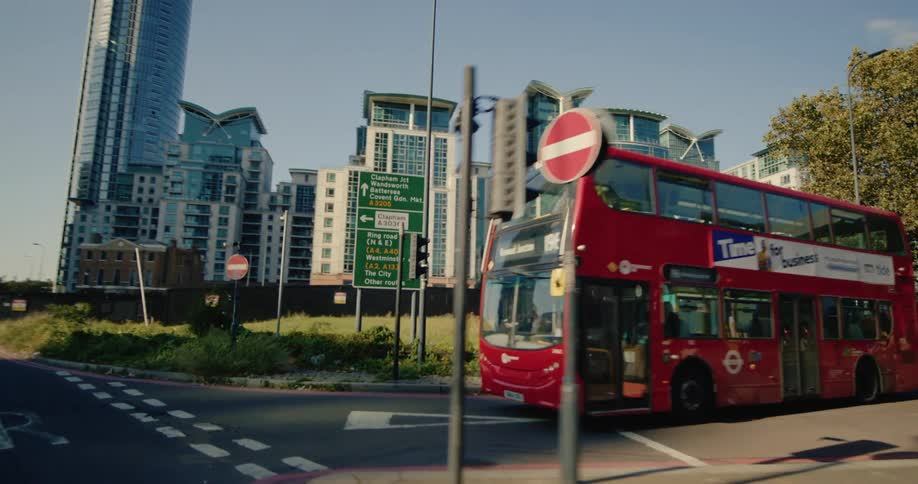 Panorama of skyscrapers in a metropolis with a red tourist bus in the foreground