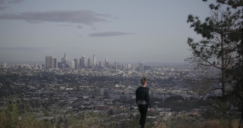 People walking a wilderness trail  on the outskirts of a large city