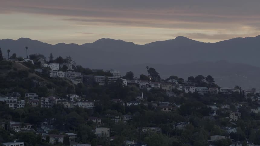 View of houses on a hillside at sunset