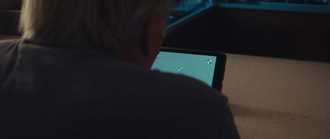 A clip of an elderly man operating a tablet