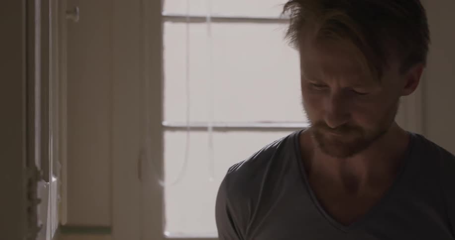 A man turns around in the kitchen
