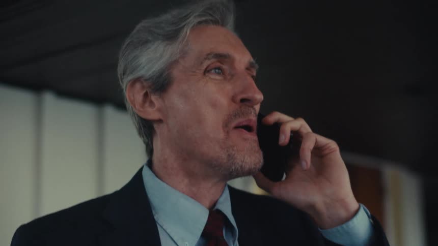 Happy man celebrating while on a phone call