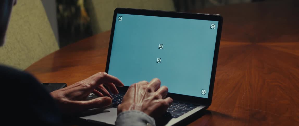 A person typing on a laptop computer with their hands visible on the keyboard