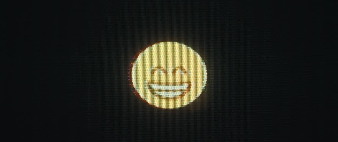 A close up of a screen displaying a succesion of emojis