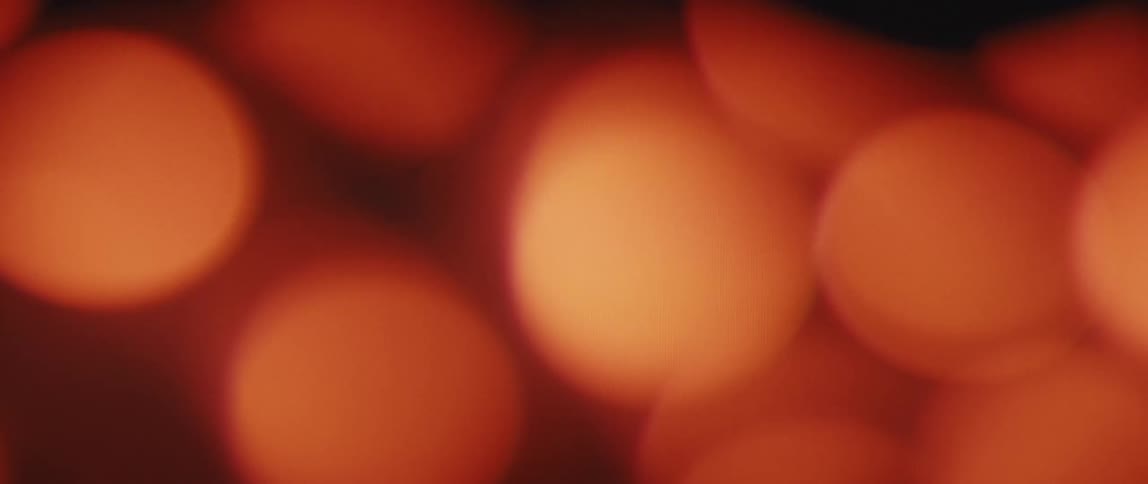 Blurred close up of orange flickering lights at night