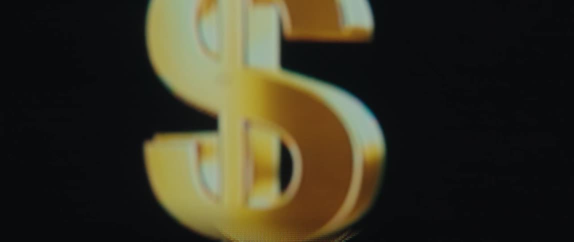 Close up of a golden dollar sign of money